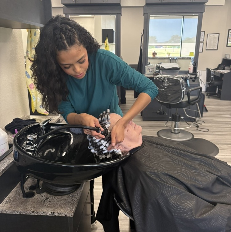 Cosmo student washing perm on client