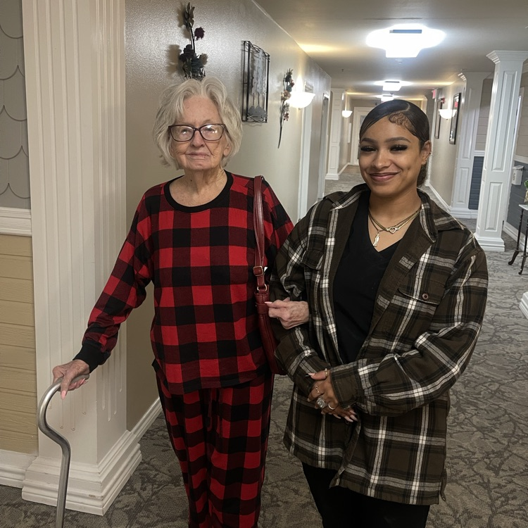 Cosmo student walking with resident