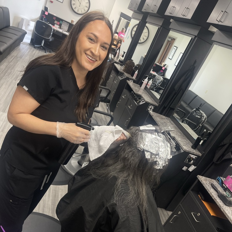 Cosmo student doing a hair service