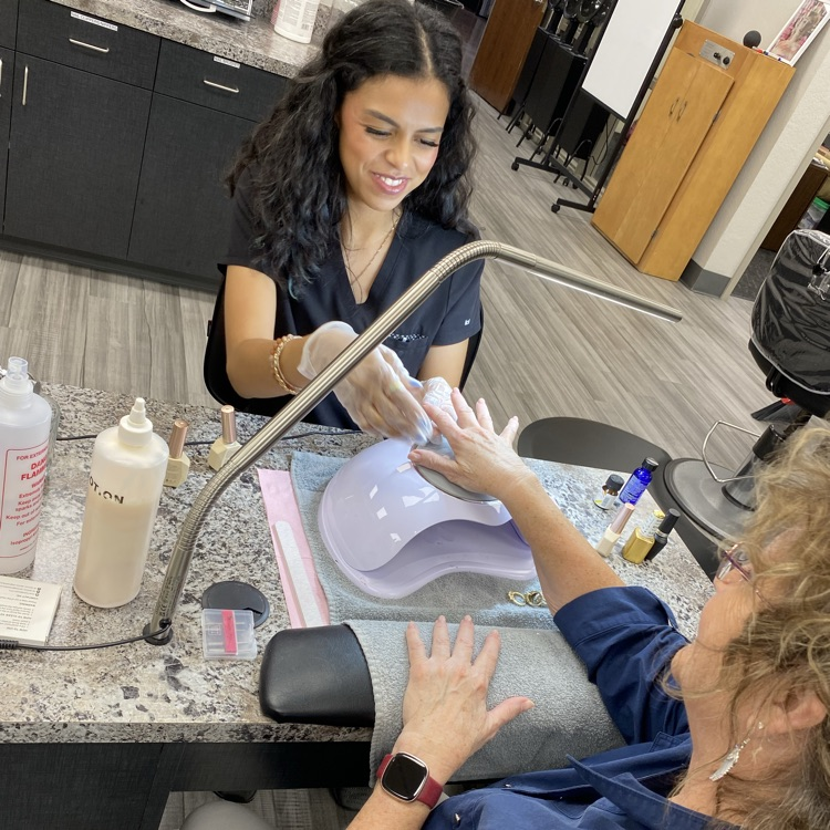 Cosmo student doing manicure