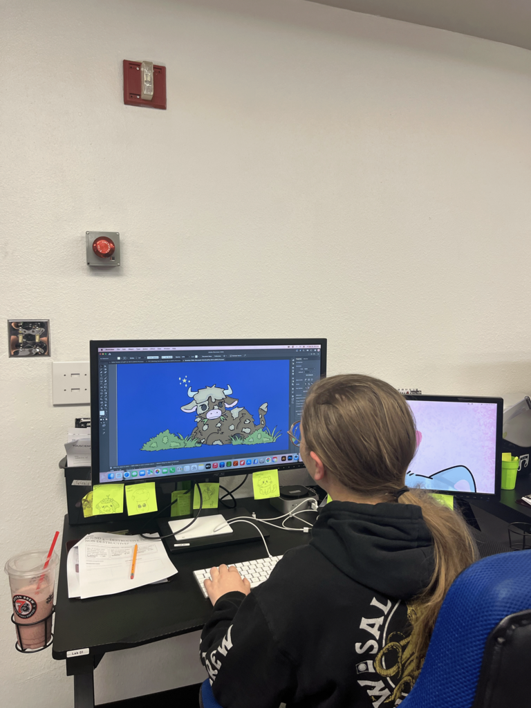 students working on illustrations for their project 