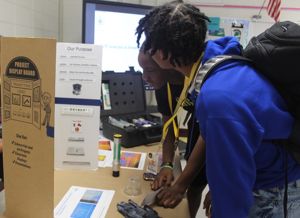 boys looking at display