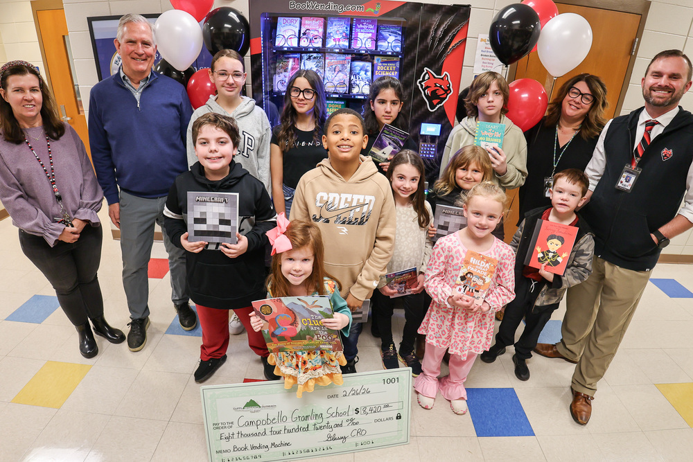 CGS students with vending machine for books