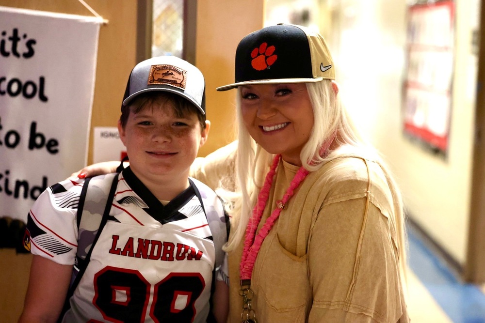 Teacher and student wearing hats