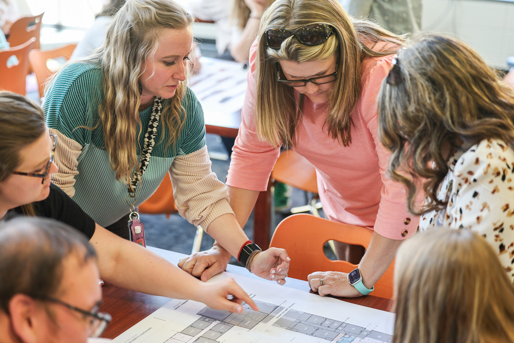 NPE teachers looking at building plans.  