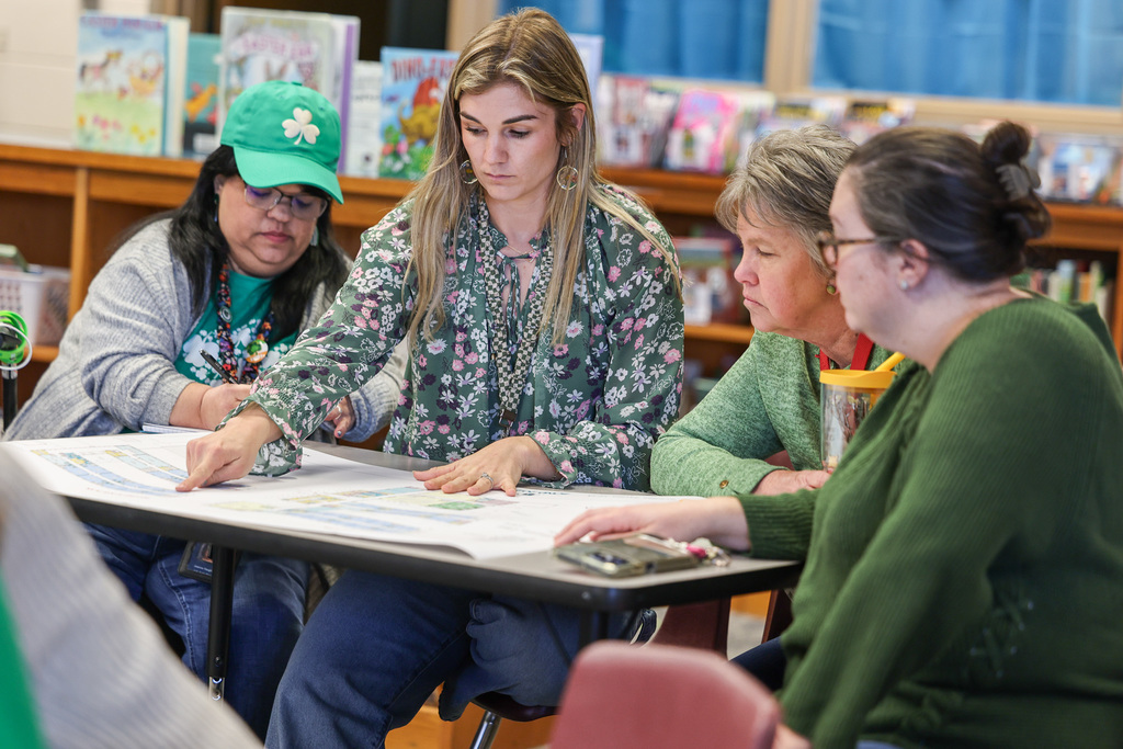 OPE teachers looking at building plans.  