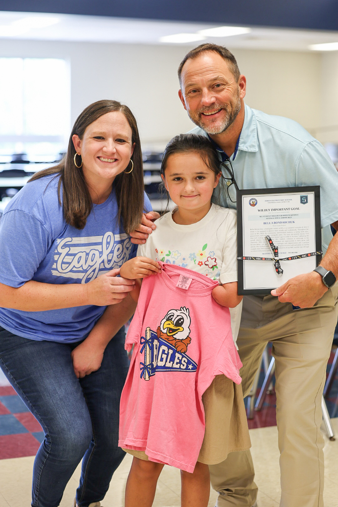 Bella with Ms. Switzer and Mr. Hodge posing for a picture
