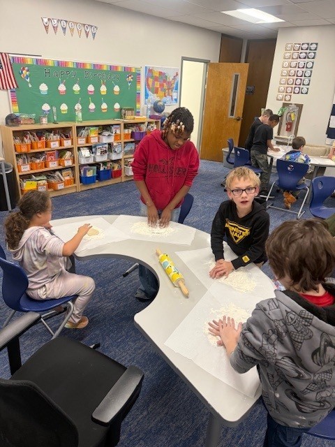 Students make gingerbread cookies