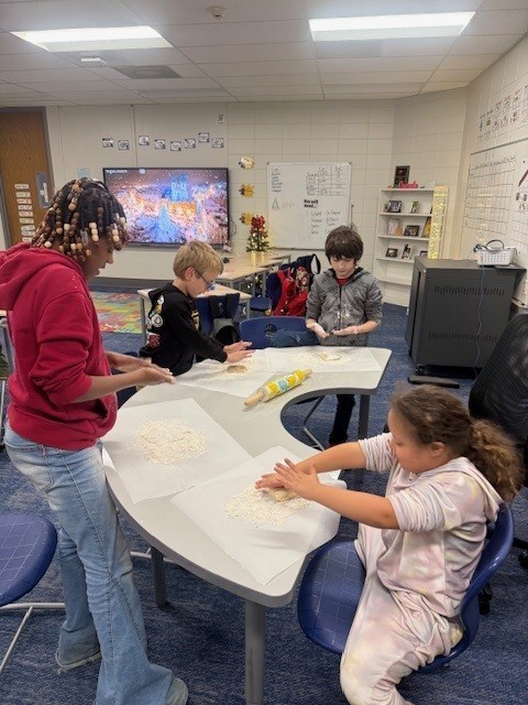 Students make gingerbread cookies