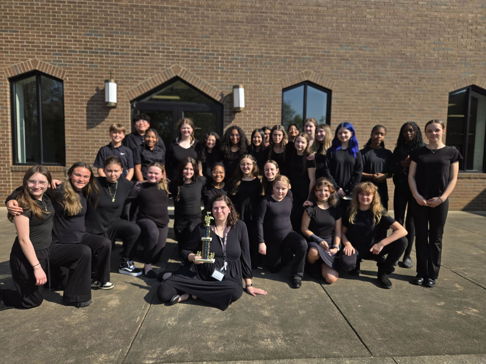 chorus students and teacher shown with their CPA  trophy