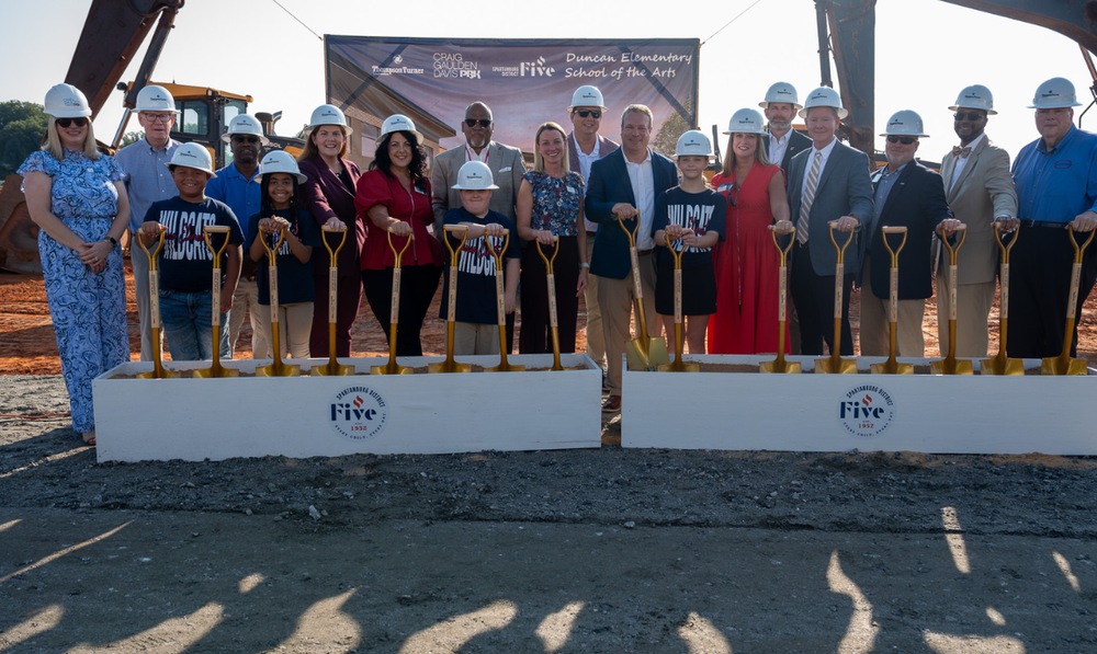 group of school leaders and students breaking ground on Duncan Elementary