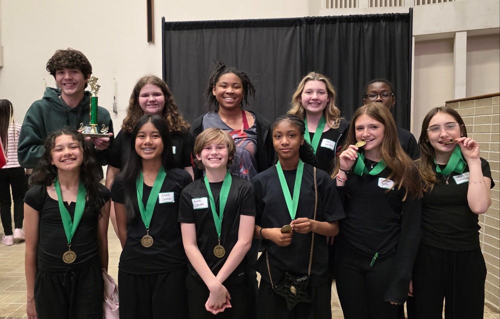 theatre students pictured with medals and trophy