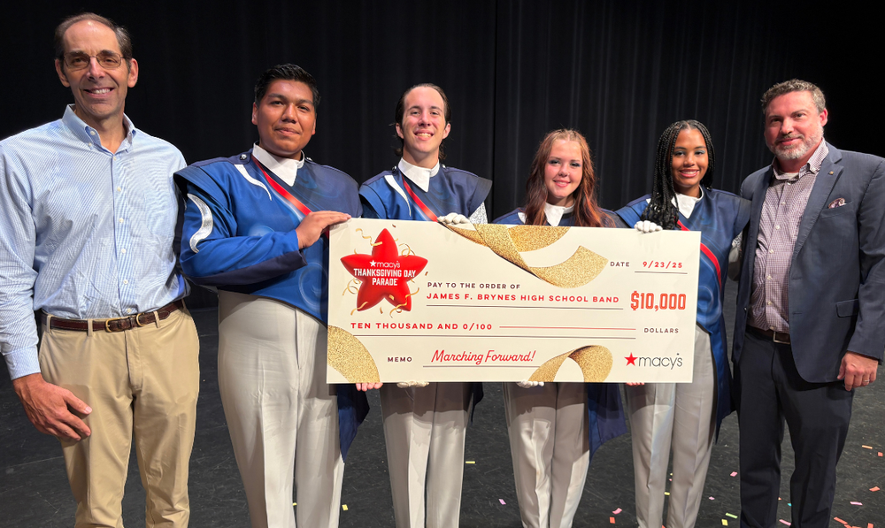band students and director with macy's check