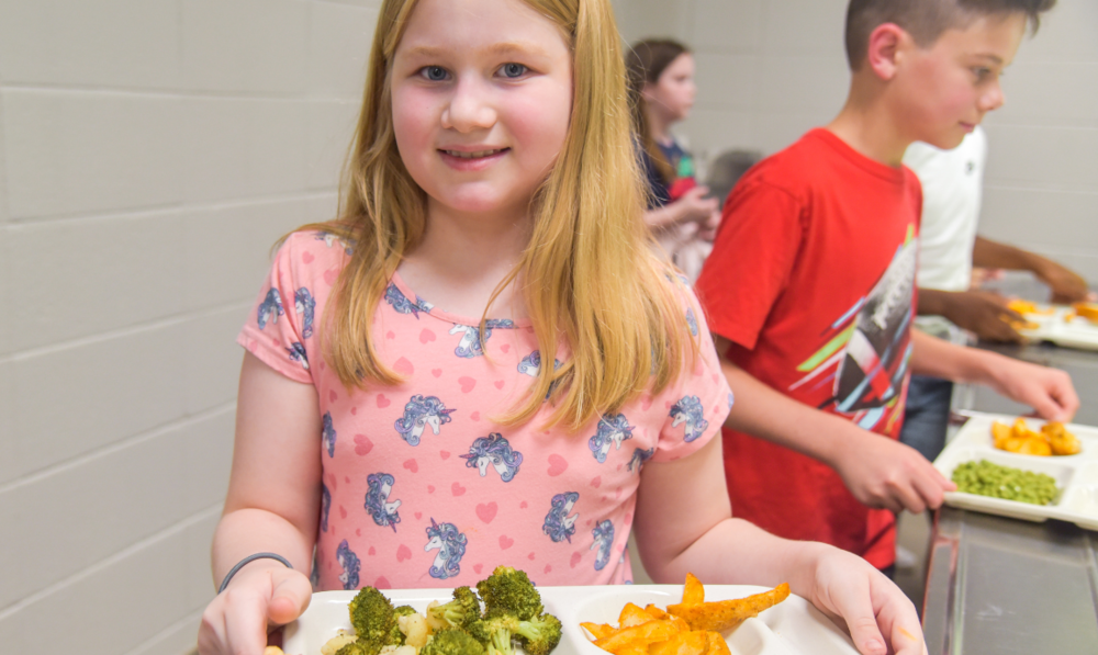 student carrying school lunch