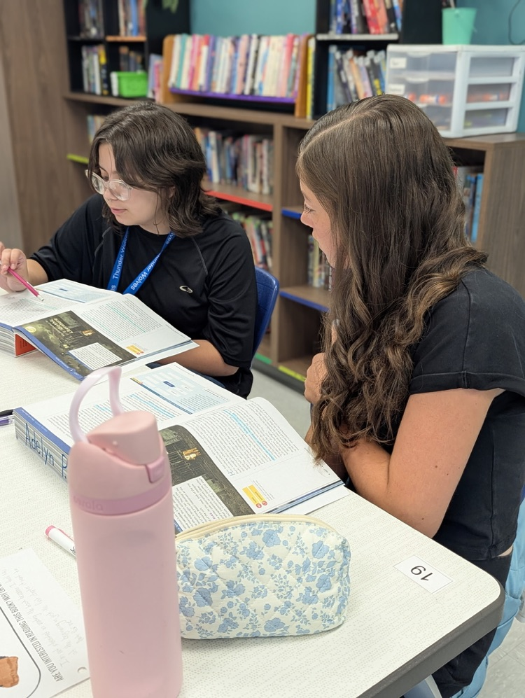 students reading in pairs