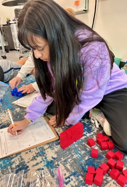 Jone's class using blocks to explore volume