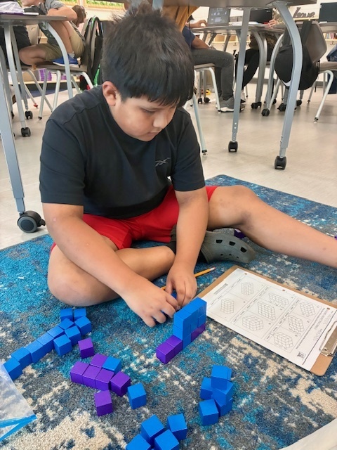Jone's class using blocks to explore volume