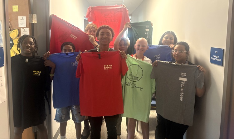 kids holding shirts