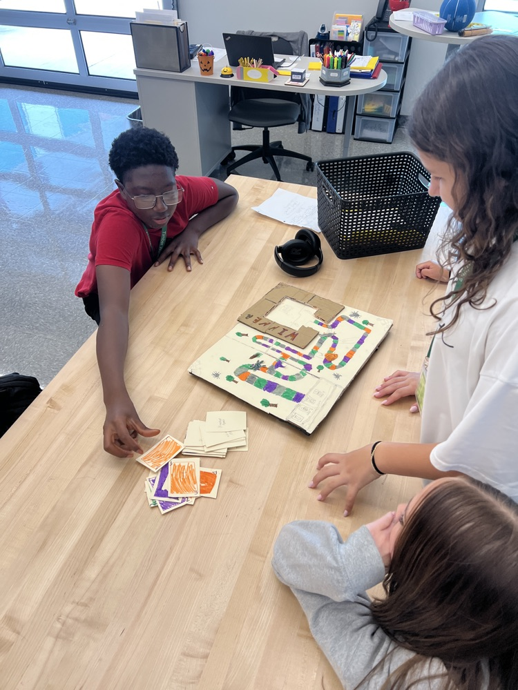 students playing board games they designed