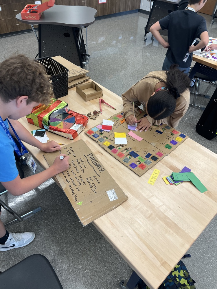 students playing board games they designed