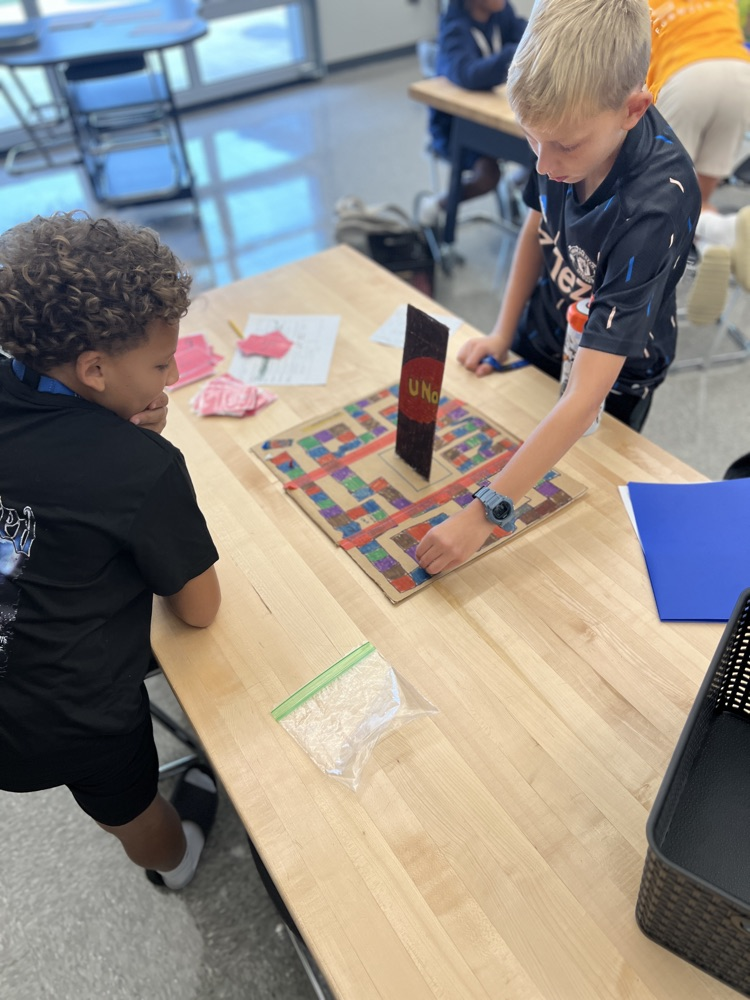 students playing board games they designed