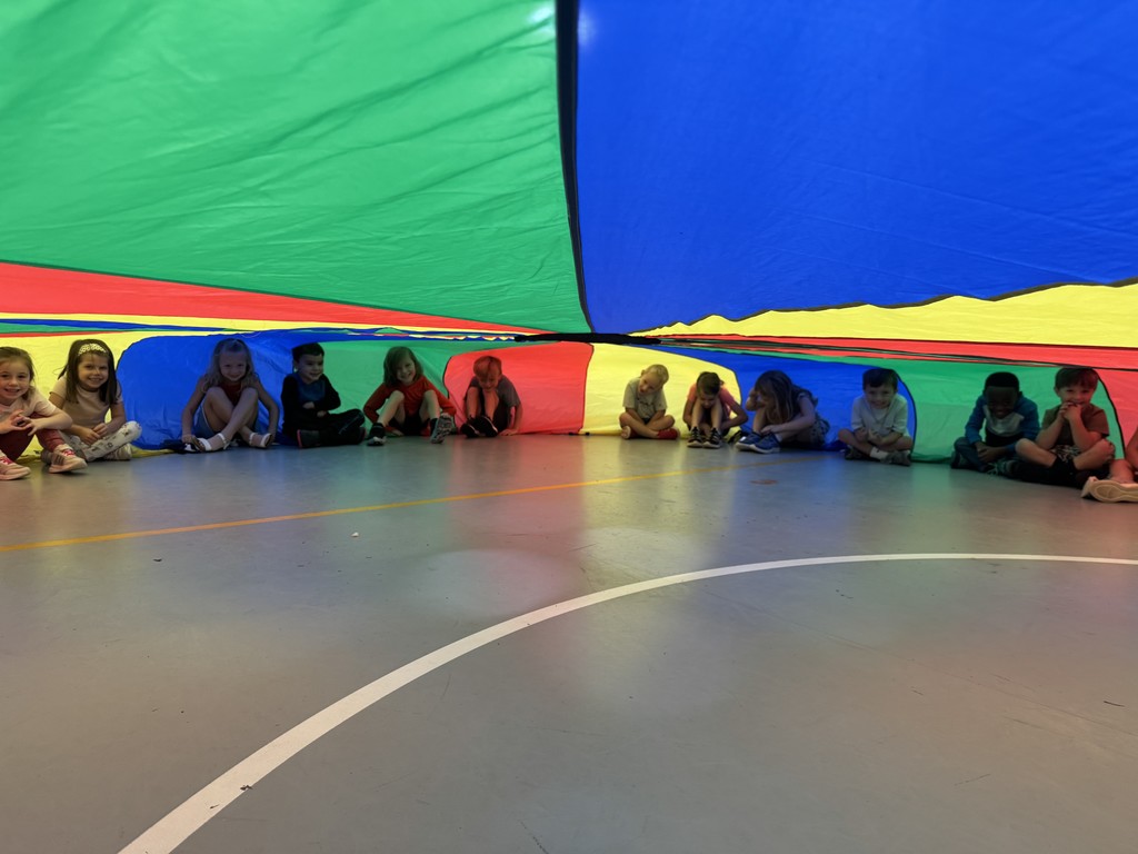 Students playing with the parachute in PE this week! 