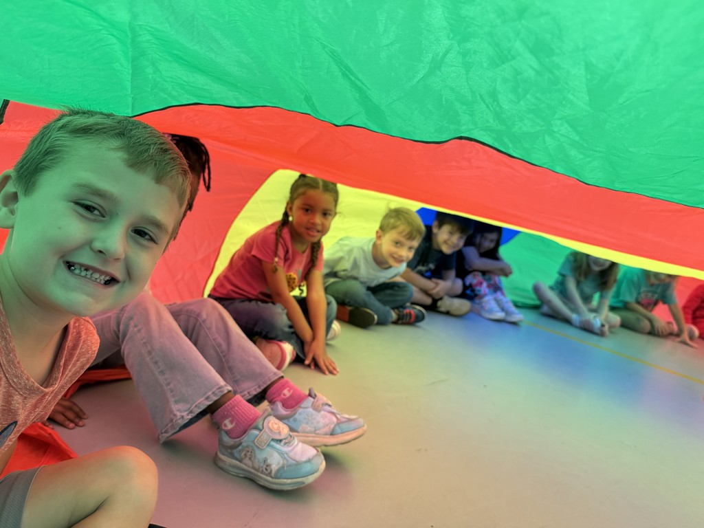 Students playing with the parachute in PE this week! 