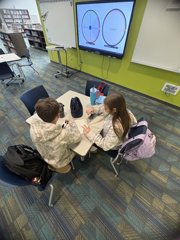 kids writing in the library