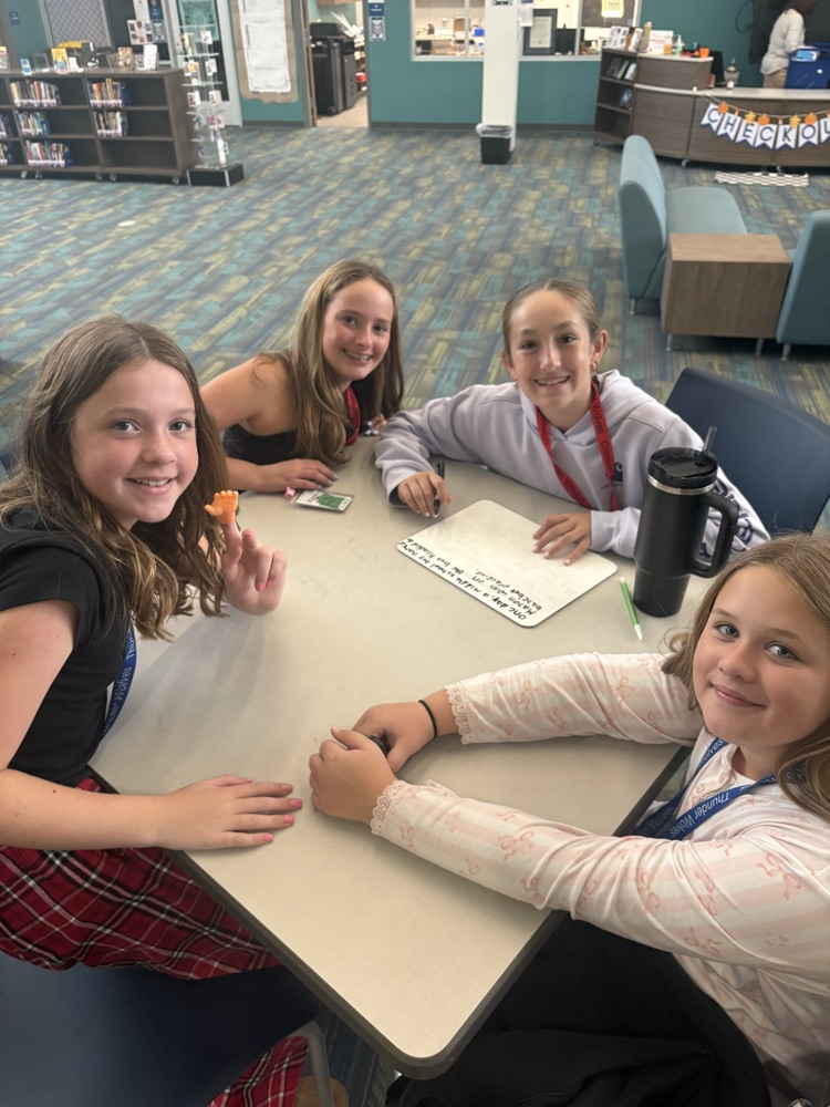 kids writing in the library