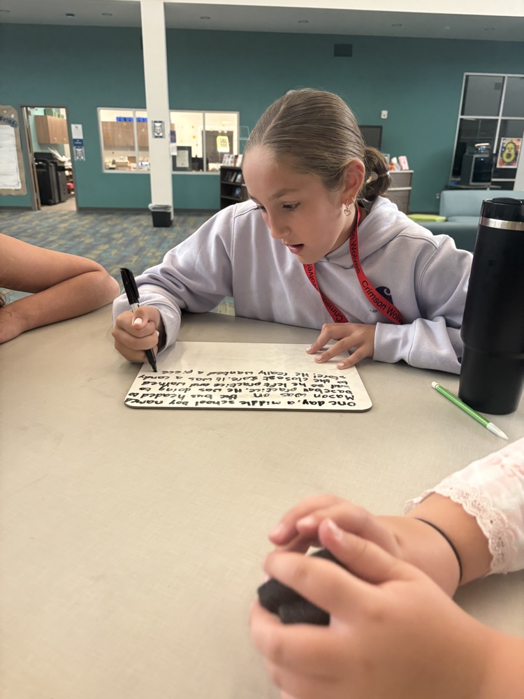 kids writing in the library