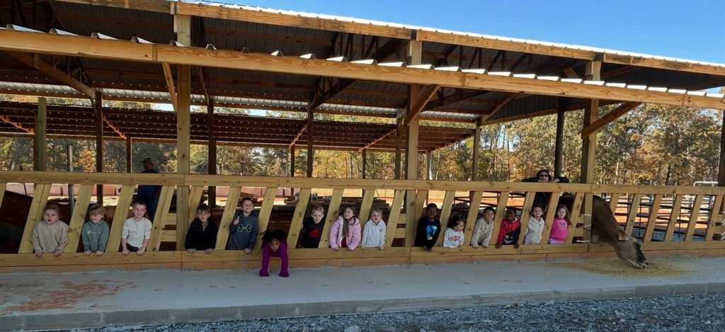 Harrington's K5 class in a barn on field trip to farm