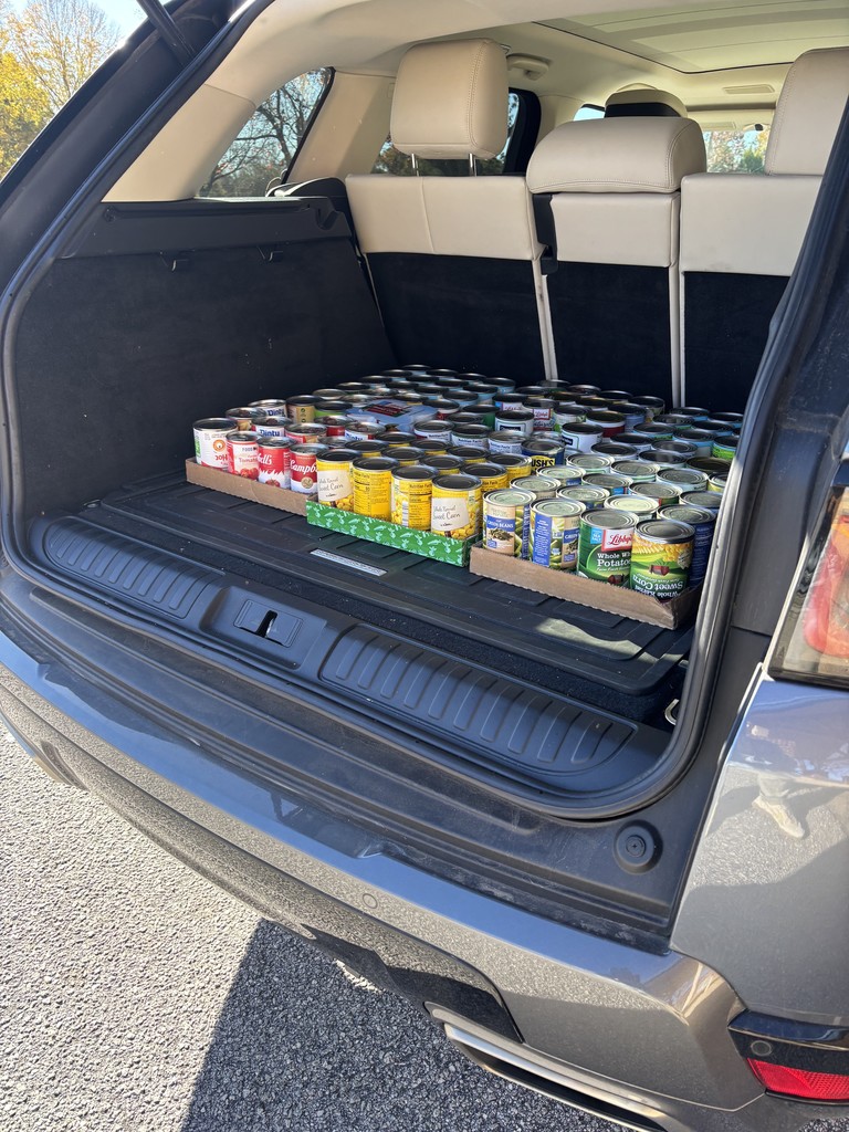 students loading canned food donations for delivery
