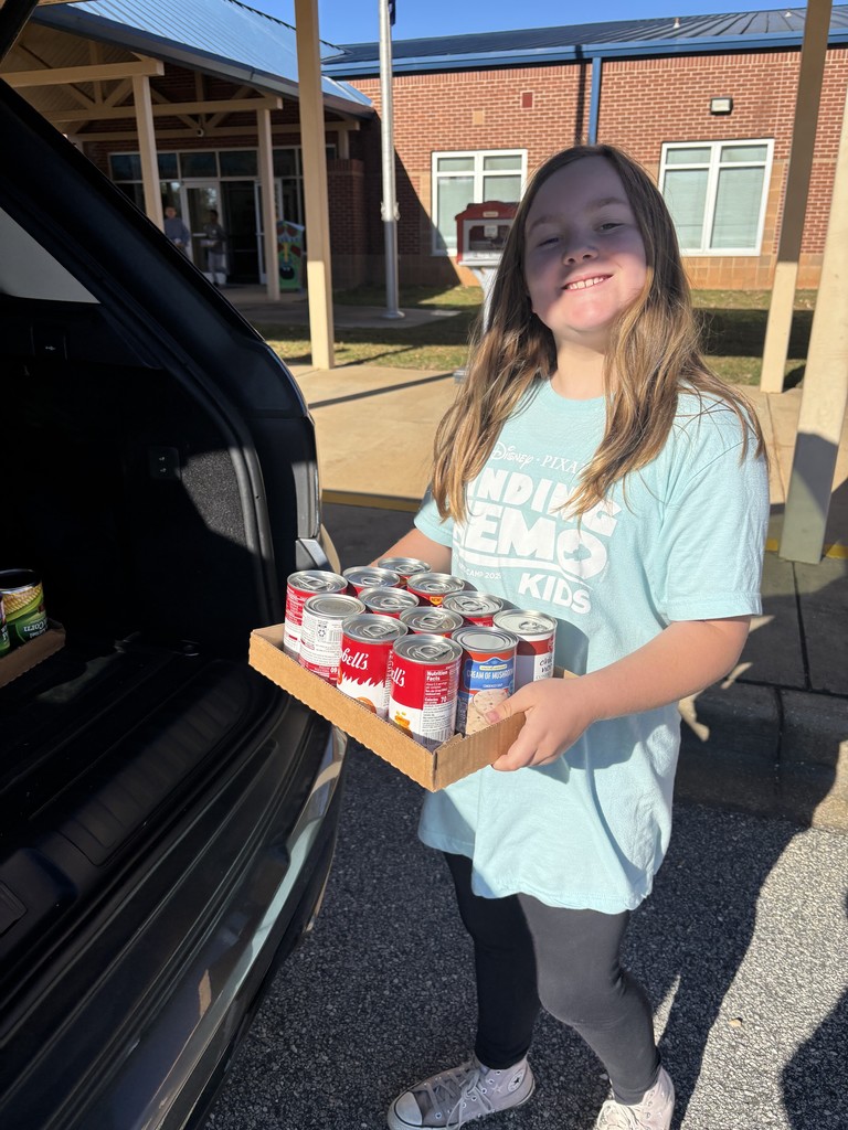 students loading canned food donations for delivery