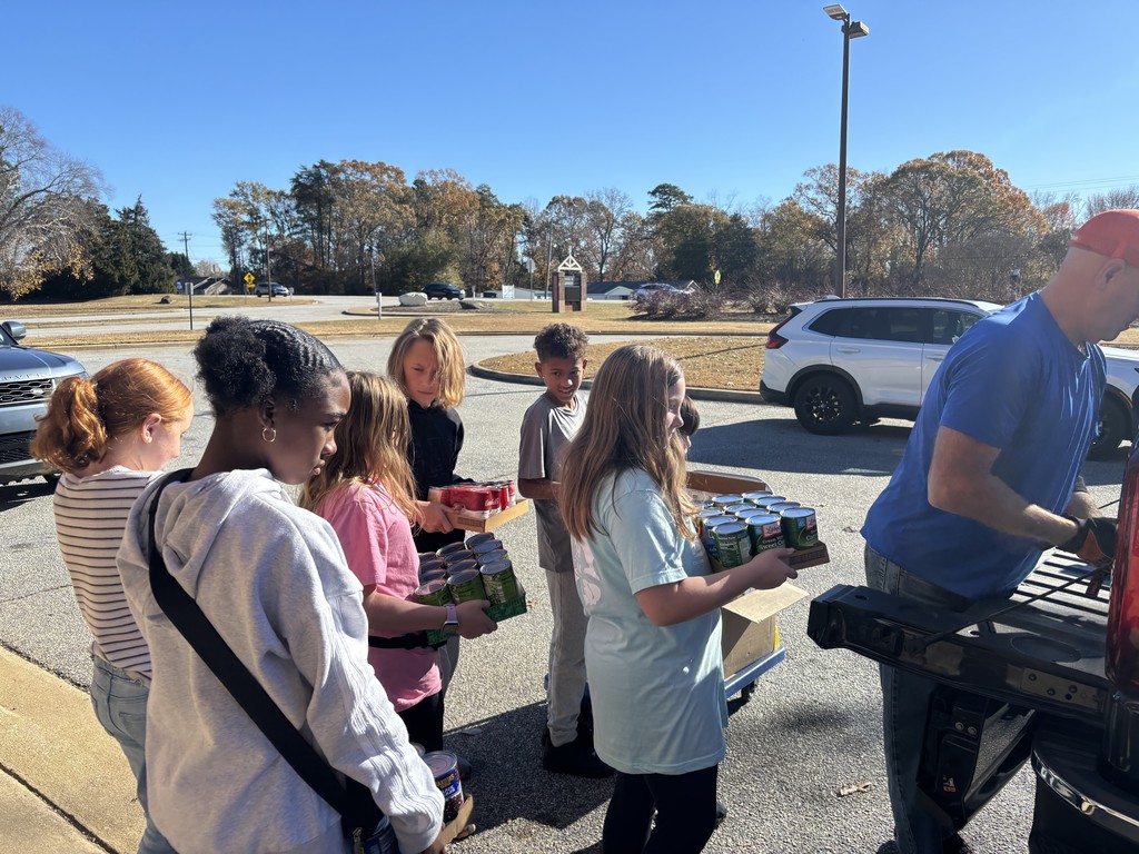 students loading canned food donations for delivery