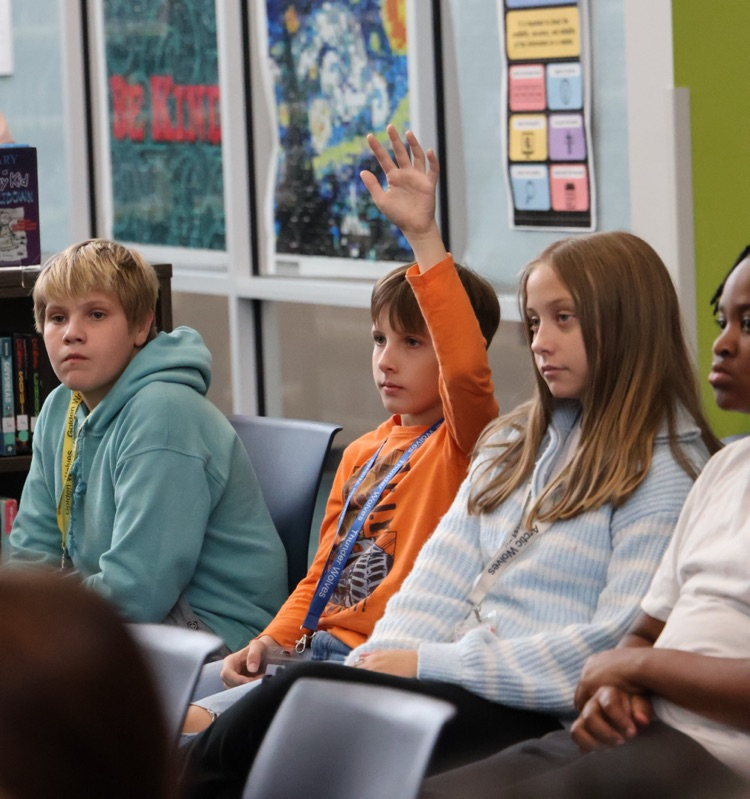 students listening to musician playing guitar 