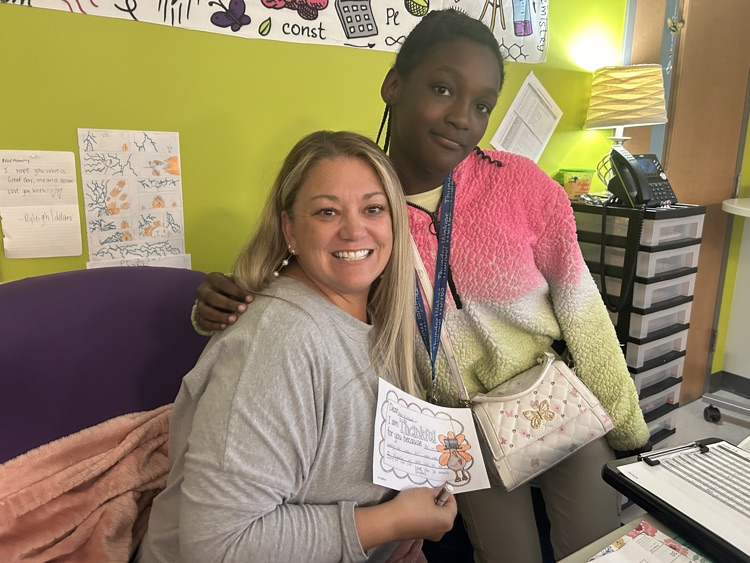 students giving teachers, thank you notes