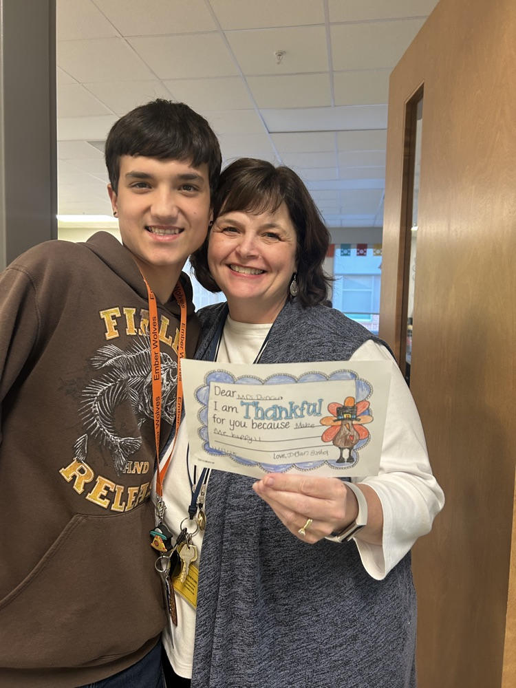 students giving teachers, thank you notes