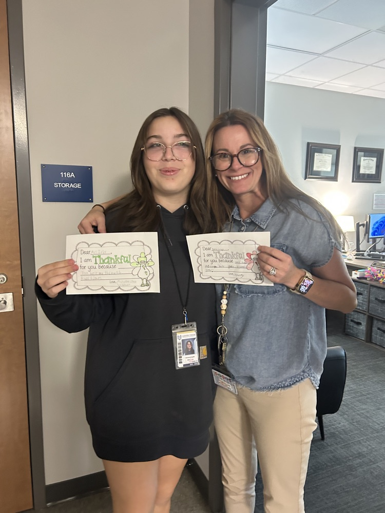 students giving teachers, thank you notes