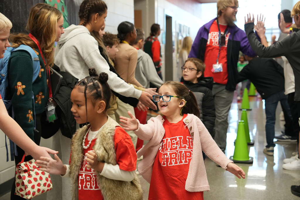 student high fiving row of students
