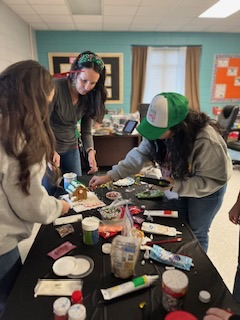 teachers participating in a ginger house decorating contest