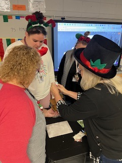 teachers participating in a ginger house decorating contest