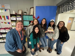 teachers participating in a ginger house decorating contest