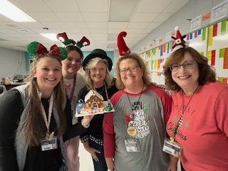 teachers participating in a ginger house decorating contest