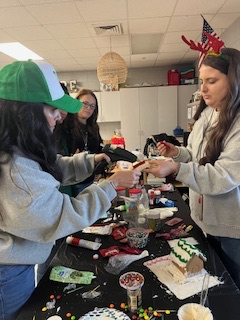 teachers participating in a ginger house decorating contest
