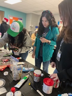 teachers participating in a ginger house decorating contest