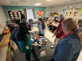 teachers participating in a ginger house decorating contest