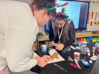 teachers participating in a ginger house decorating contest