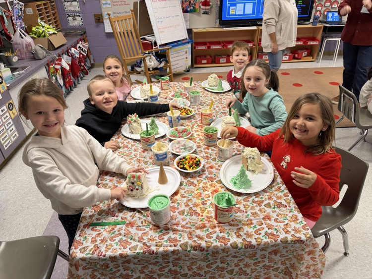 students decorating gingerbread houses