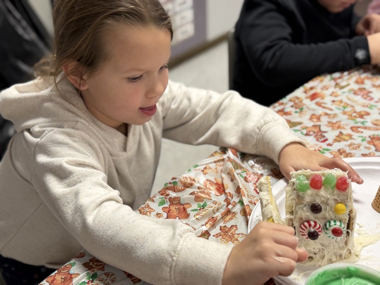 students decorating gingerbread houses