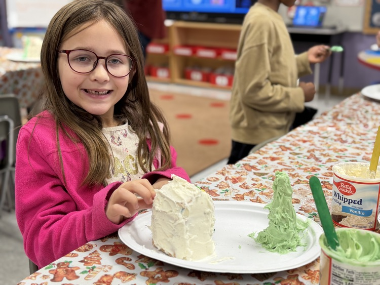 students decorating gingerbread houses